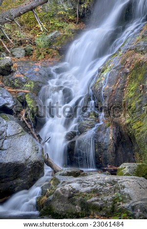 Beautiful autumn waterfall in deep the woods of a mountain.