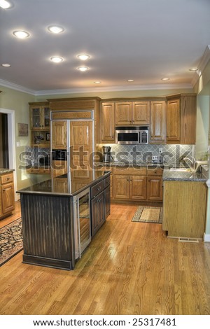 Luxury modern kitchen with wooden cabinets and hardwood flooring.