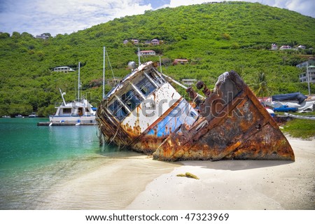 Sunk tug boat on the shoreline of a beautiful tropical island.