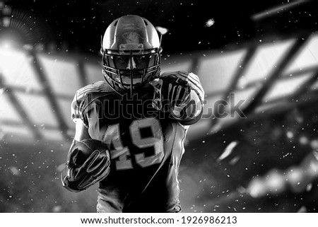 Football Player player with a superhero pose wearing a blue uniform on a black background with blue lights.
