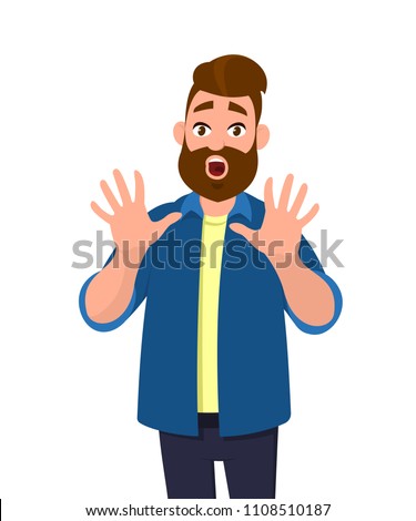 Man with scared expression on his face making frightened gesture with his palms as if trying to defend himself from someone. Young man making a scared gesture.