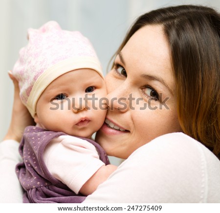 Mother holds cute 3 months baby