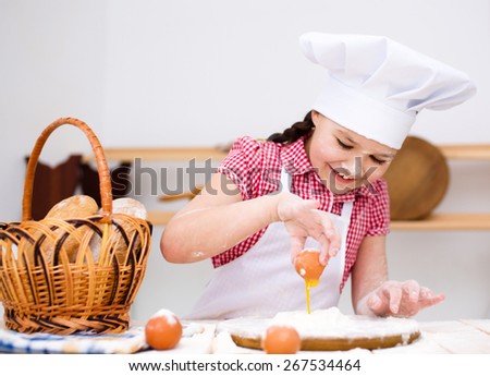 Cute girl making bread in the kitchen