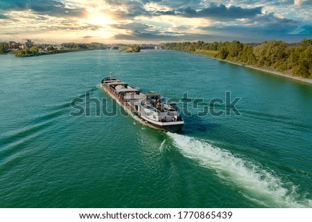 Barge travels on the Rhine in the sunset Imagine de stoc © 