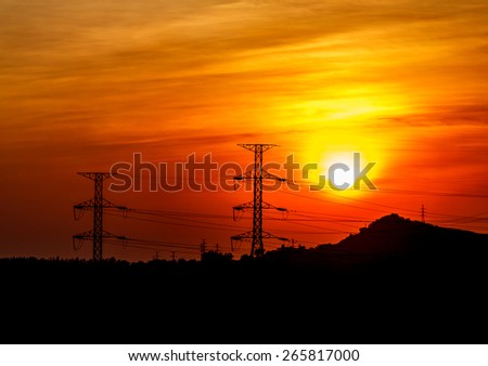 Power transmission line with the sun in the evening.