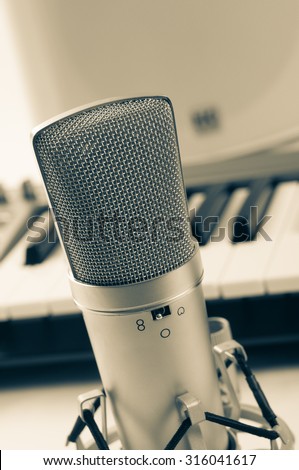 Microphone in recording studio on a white background. Vintage style