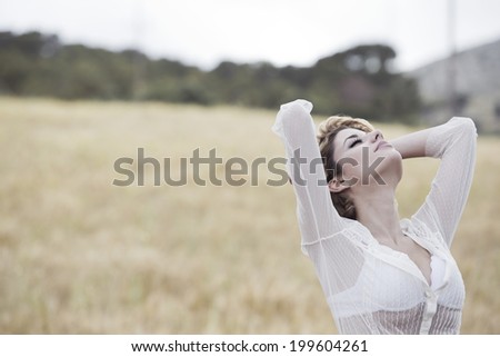 Relaxed girl in the countryside in a white dress