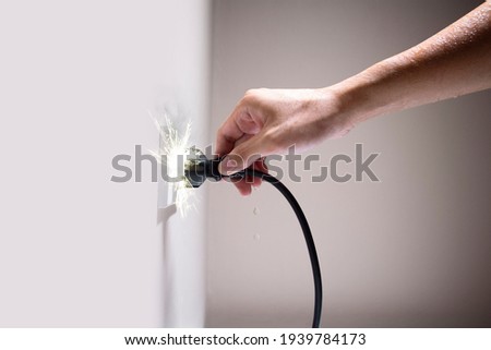 Wet hand connecting electrical plug cause electric shock, Idea for causes of home fire, Electric short circuit, Electrical hazard can ignite household items, Residential building electrical fires.