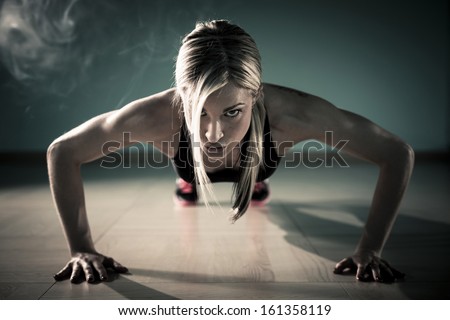 Fitness woman exercising push ups