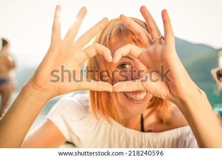 Woman and heart shaped fingers
