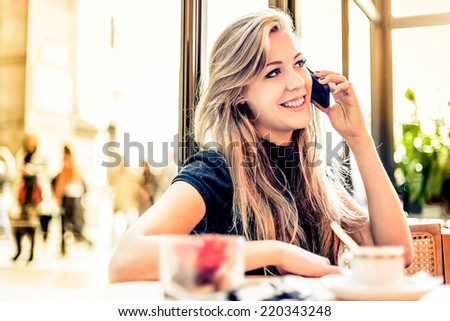 Photo of Woman using mobile phone in a Bar