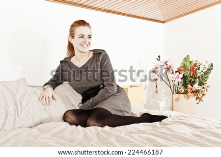 Woman sitting on sofa. Home sweet home.