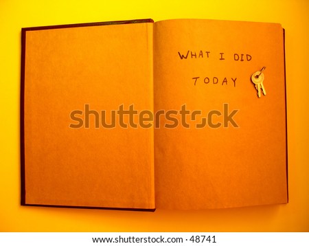 An open journal with a set of keys sitting on the top next to the phrase \