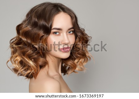 Portrait of a woman with curly hair. Haircut. Shine and hair care 商業照片 © 