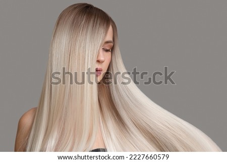Similar – Image, Stock Photo Young blonde long haired woman standing from petrol wall in red dress smiling at camera