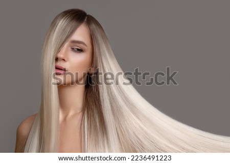 Similar – Image, Stock Photo Young blonde long haired woman standing from petrol wall in red dress smiling at camera