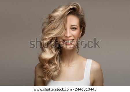 Similar – Image, Stock Photo Young blonde long haired woman standing from petrol wall in red dress smiling at camera
