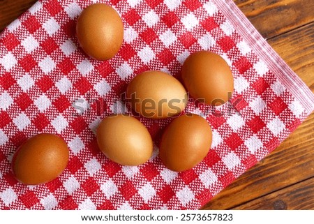 Similar – Image, Stock Photo Chicken eggs on napkin on wooden table