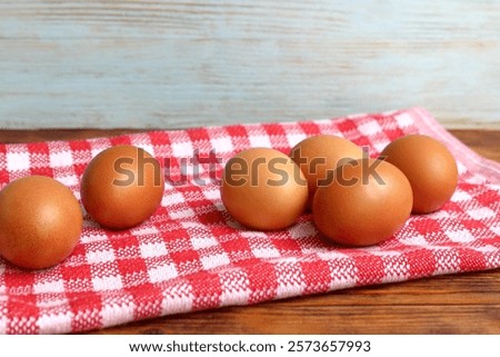 Similar – Image, Stock Photo Chicken eggs on napkin on wooden table