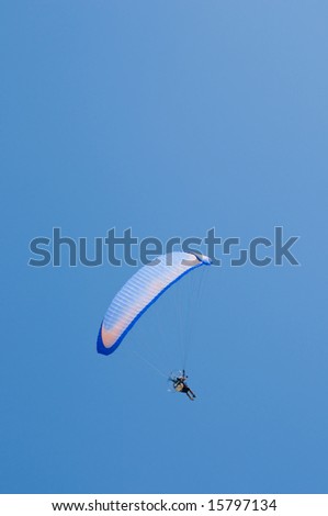 Motorized paraglider, blue and orange wing