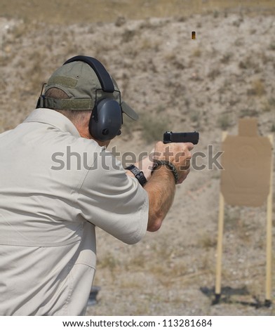 Handgun shooter who is target practicing at the range