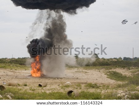 Black smoke rising above a car that has just explosed