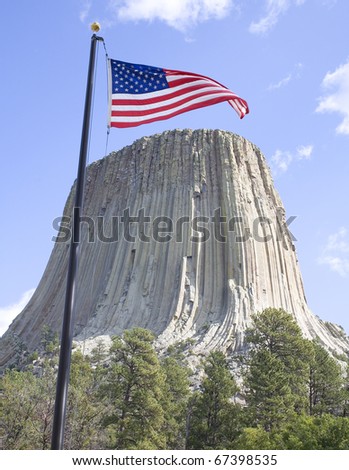 American flag waving in a breeze over Devils Tower