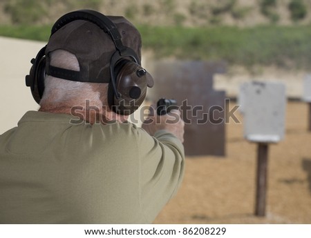 Handgun shooter readying to shoot at steel targets