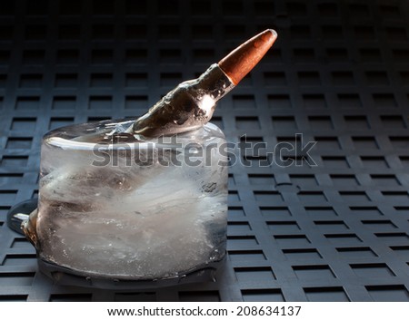 Ammunition stuck in a block of ice that is melting