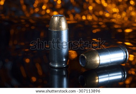 Ammunition for a pistol that has hollow point bullets with an orange background