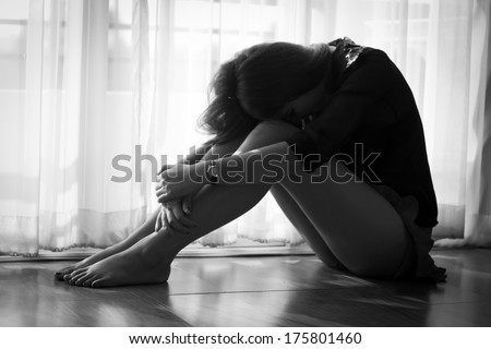 sad woman sitting on floor