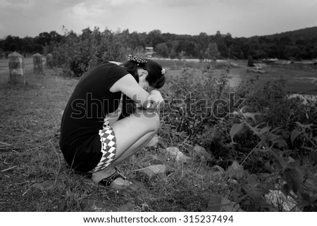 Asia woman Hugging her Knees with Eyes Closed,black and white