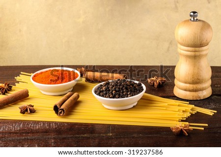spices with spaghetti isolated on wooden background