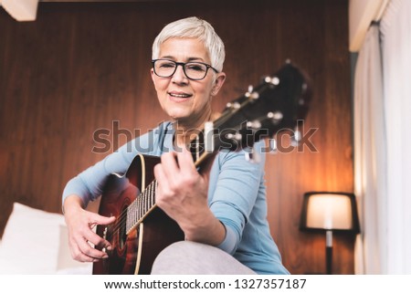 Similar – Image, Stock Photo Calm woman playing guitar in bedroom