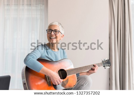 Similar – Image, Stock Photo Calm woman playing guitar in bedroom