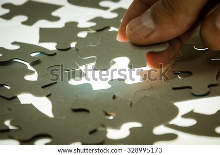 Man puzzle fits on a light surface