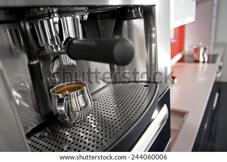 coffee making machine closeup composition steel cup low deep of field