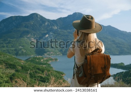 Similar – Image, Stock Photo Woman with backpack taking selfie on smartphone on background of mountains