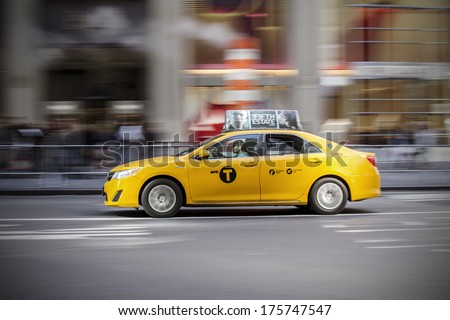 NEW YORK - OCTOBER 12: Panning shot of a NYC Taxi Cab at fifth avenue. New York City, on October 12, 2013.