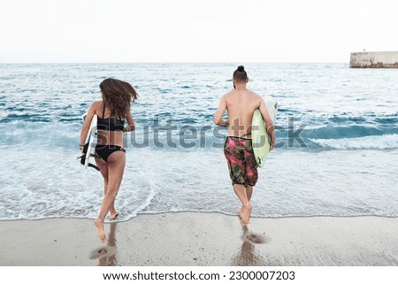 Similar – Image, Stock Photo Anonymous female surfer walking on beach with surfboard
