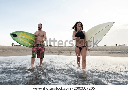 Similar – Image, Stock Photo Content female surfer walking on beach with surfboard