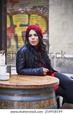 Young woman sitting alone in a restaurant