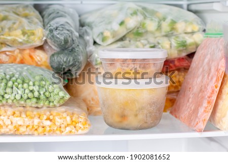 Frozen food in the freezer. Frozen vegetables, soup, ready meals in the freezer
