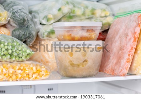 Frozen food in the freezer. Frozen vegetables, soup, ready meals in the freezer