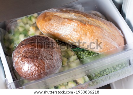 Frozen bread in the home freezer. The frozen products. Long life food storage concept.