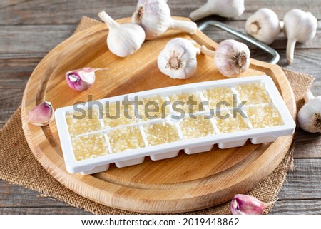 Frozen garlic. Frozen garlic puree on wooden table. Frozen food Concept