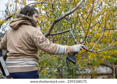 Similar – Foto Bild Männlicher Landwirt beim Beschneiden eines Obstbaums