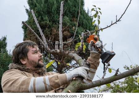 Similar – Foto Bild Männlicher Landwirt beim Beschneiden eines Obstbaums