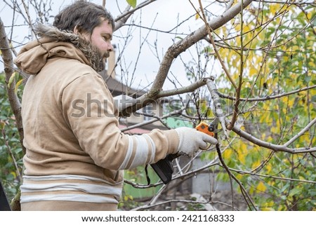 Similar – Foto Bild Männlicher Landwirt beim Beschneiden eines Obstbaums