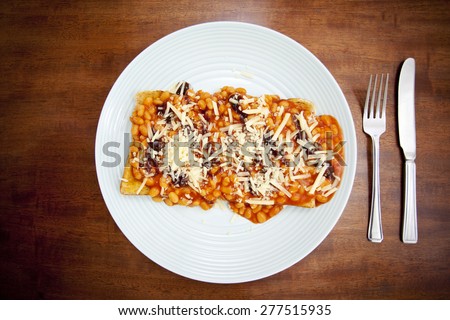 Baked beans on toast with brown sauce and cheese